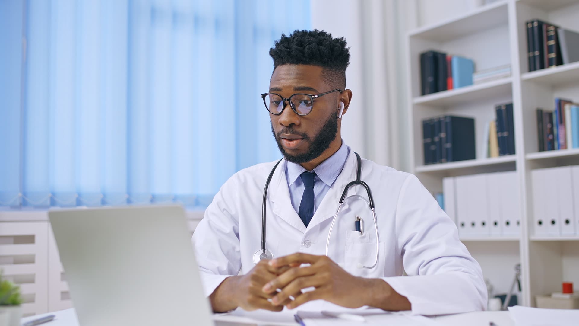 Doctor talking to patient via computer screen